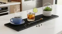 Bar mat on a white kitchen counter with drinks